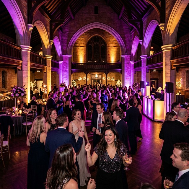 Ballroom event with dramatic purple and gold reception lighting.